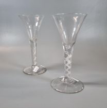 Two similar Georgian design air twist stem wine glasses/goblets with a trumpet bowl on a conical