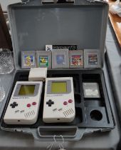 Two vintage Nintendo Gameboys and six games in an unofficial case. Games to include: Donkey Kong,