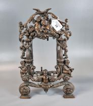 Rococo style oxidised metal openwork photograph/mirror frame decorated with cherubs, birds and