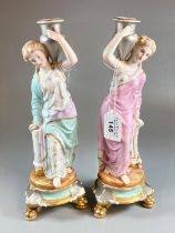 Pair of continental porcelain classical figures of water carriers on gilt plinths. (B.P. 21% + VAT)