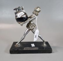 Unusual chrome plated table lighter in the form of a striding female Pierrot holding a large