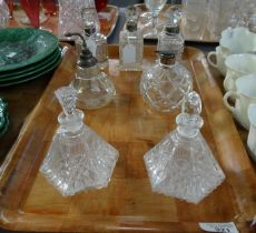 Tray of seven cut and moulded glass scent bottles and atomisers to include: two with silver