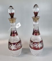 Pair of hobnail cut lead crystal flash cut ruby ground foliate silver collared decanters with