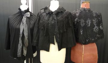 Three black Victorian capes and capelets to include: a sequin and beaded lace edged capelet, a black