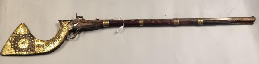 Antique Arab muzzle loading percussion gun with brass bands and brass sheathed studded stock. (B.