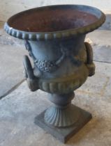 Weathered cast iron Campana shaped two handled garden urn. 61cm high approx. (B.P. 21% + VAT)