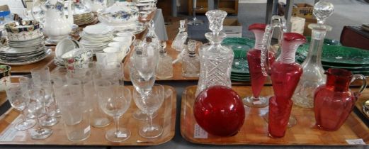 Two trays of glassware to include: two cut glass decanters with stoppers and star cut bases, various