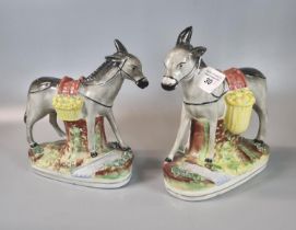 Pair of 19th century Staffordshire Pottery Donkeys, each with baskets of fruit on naturalistic