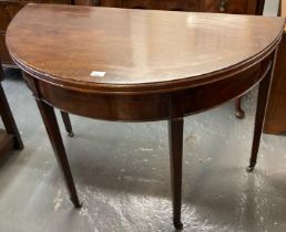 George III mahogany demi-lune fold 0ver tea table on tapering legs and casters. (B.P. 21% + VAT)