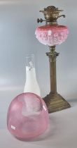 Early 20th century double oil burner lamp having cranberry etched shade above a pink opaline glass