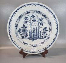 18th century Delft tin glazed earthenware blue and white shallow dish/charger decorated with flowers