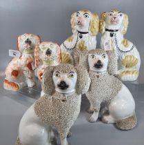 Collection of Staffordshire fireside Spaniels, one pair with basket of flowers in their mouths,