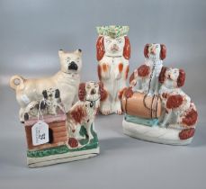 Group of four Staffordshire Pottery items to include: red and white Spaniels with kennel 14.5cm