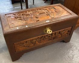 20th century camphor wood trunk/chest ornately carved with figures amongst pagodas. (B.P. 21% + VAT)