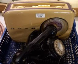 Bush vintage reproduction transistor radio and vintage rotary black telephone.