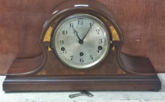 Edwardian inlaid mahogany three train arched mantle clock with silvered Arabic face. 25cm high
