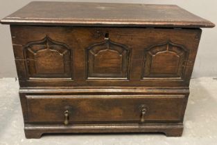 18th century Welsh oak coffwr bach, the iron hinged moulded lid above three ogee fielded panels, the