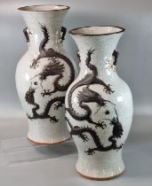 Mirror matched pair of Chinese porcelain baluster vases, depicting two writhing brown coloured