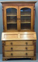 Late Victorian oak bureau bookcase, the moulded cornice above two glazed doors, the interior