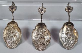 Three Dutch silver spoons with repoussé decoration of a fisherman with his catch and heart shaped