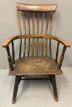 19th century primitive design oak and elm stick back armchair on solid moulded seat, turned legs and