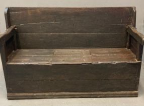 18th century oak Monk's bench/settle with shaped arms and boxed seat. 164x58x1014cm approx. (B.P.