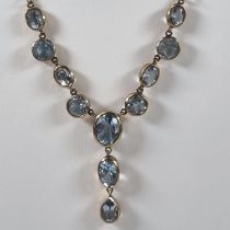 9ct gold eleven stone blue topaz necklace. 10g approx. (B.P. 21% + VAT)