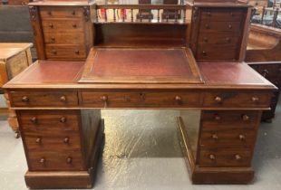 Victorian mahogany Dickens style knee hole desk, the gallery back and fitted drawers above a slope