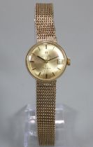 Ladies Omega 9ct gold automatic bracelet wristwatch, having gold coloured satin face with date