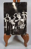 An original 1960s Beatles postcard in black and white featuring the band playing,