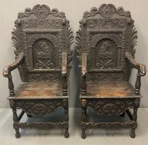 Pair of Victorian stained oak 17th century style Wainscot open armchairs, ornately carved with