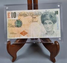 Banksy, a Di'Faced £10 note, an original Bank of England £10 note, the Queen's face substituted with