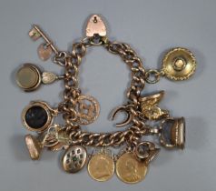 9ct gold curb link charm bracelet with assorted charms including: Masonic, harp, Intaglio seal