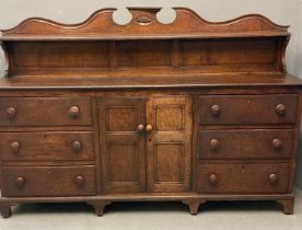 Early 19th century Welsh oak sideboard, the shaped gallery back above a moulded top with an