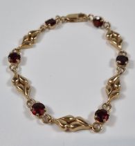 9ct gold six stone garnet bracelet. 10.6g approx. 19cm long approx. (B.P. 21% + VAT)