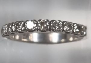 White metal half hoop ten stone diamond eternity ring. 3.3g approx. Size M. (B.P. 21% + VAT)