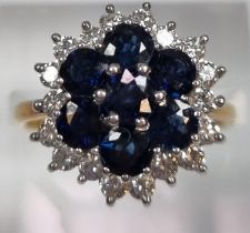 18ct gold diamond and sapphire ring comprising eighteen diamonds and seven sapphires. 5.2g approx.