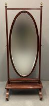 Edwardian mahogany inlaid cheval type mirror of oval form with bevel plate standing on undershelf
