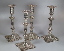 Two similar pairs18th century Irish silver candlesticks with removeable repoussé sconces above