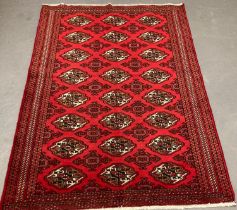 Rich red ground Turkmen double knot rug, with traditional Bukhara designs. 186x125cm approx. (B.P.