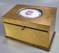 Late 19th century brass fall front stationery box, the top inset with porcelain panel/tablet in