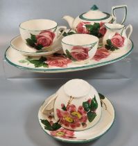 19th century Llanelly pottery cabaret set in the 'Rose' design comprising: two cups and saucers,