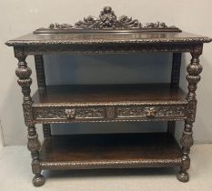 Late Victorian stained oak dining room suite comprising three tier buffet, sideboard, octagonal