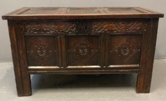 Late 17th century oak coffer, the hinged lid and moulded top above a carved frieze and iron plate