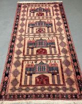 Unique Persian Nomadic pink ground rug with repeating floral and lozenge designs. 216x108cm