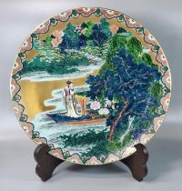 Japanese porcelain Kutani polychrome charger depicting a woman on a boat playing a flute in a