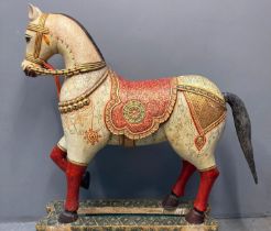 An Indian polychrome hand painted wooden Wedding Horse with foliate decoration, gilded