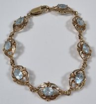 9ct gold blue eight stone bracelet, probably topaz. 12.2g approx. 19.5cm long approx. (B.P. 21% +