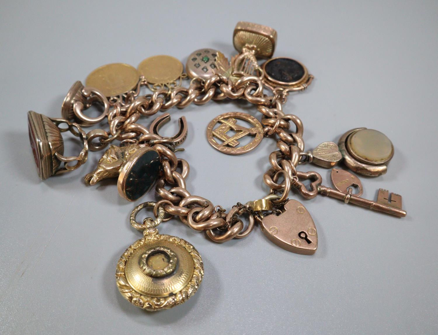 9ct gold curb link charm bracelet with assorted charms including: Masonic, harp, Intaglio seal - Image 3 of 4