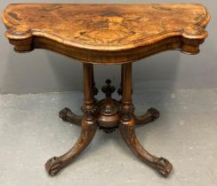 Victorian walnut fold over card table, the moulded and shaped top with hinged lid, above carved